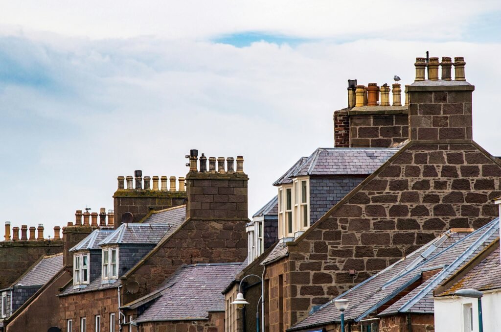 A picturesque view of old town rooftops showcasing traditional architecture and chimneys., Chimney Repair, Contact Us